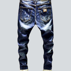 Whiskered distressed jeans for men