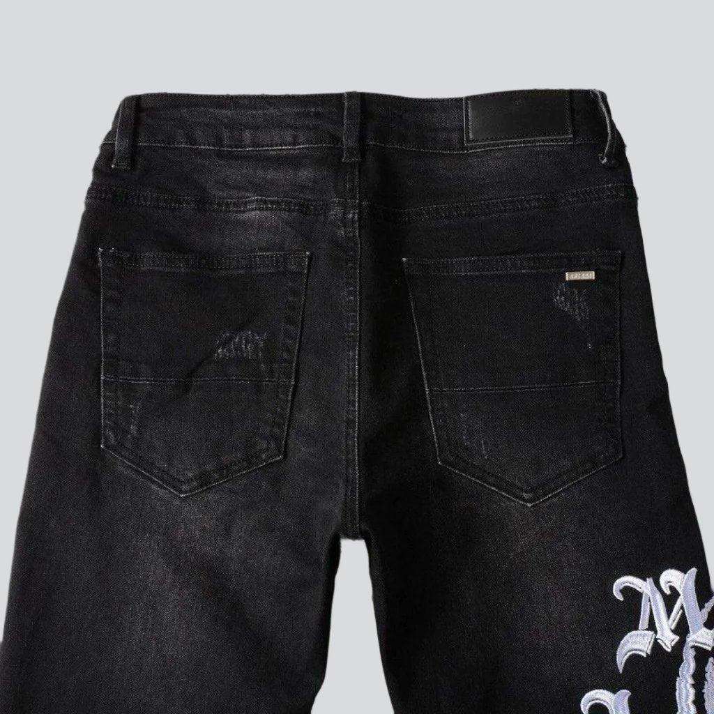 Schwarze Skinny Jeans mit weißer Stickerei